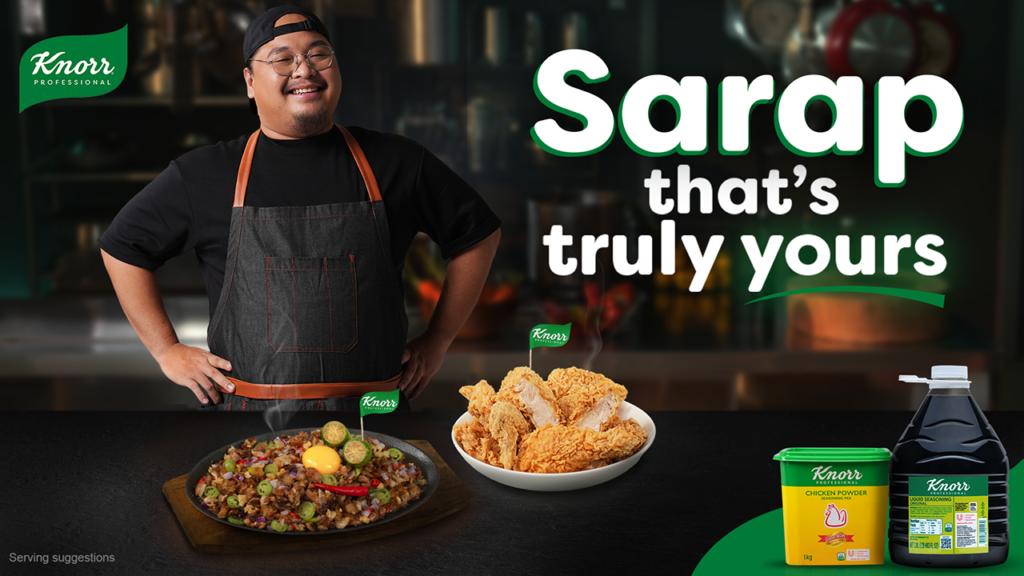 Ninong Ry posing in the kitchen in front of Knorr seasoning products